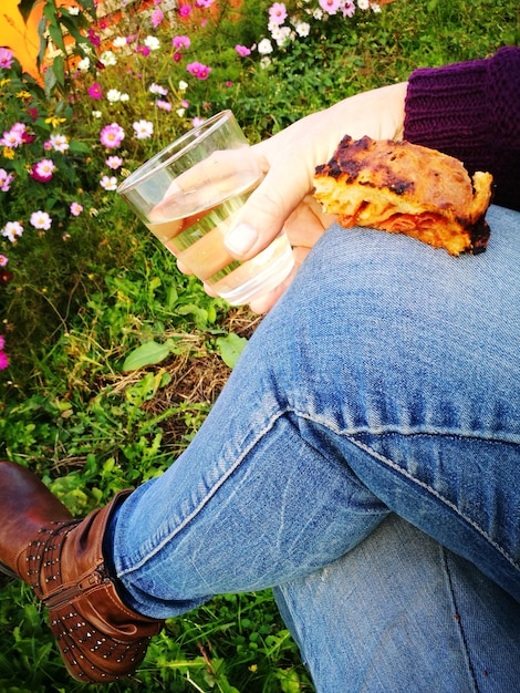 Low section of woman holding a drink