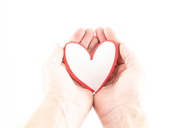 Photo low section of woman holding heart shape against white background