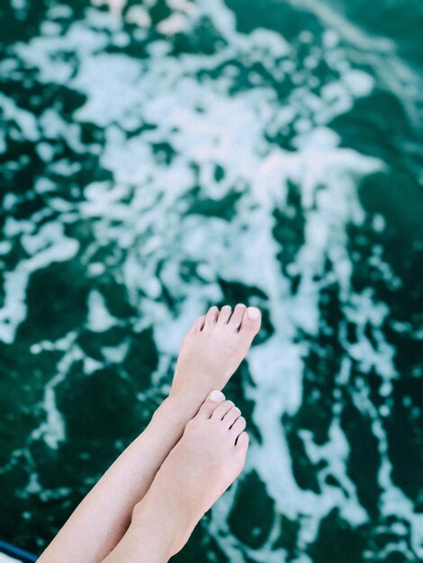 Low section of woman legs at sea