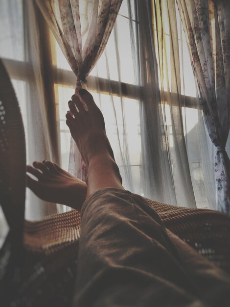 Photo low section of woman relaxing on chair at home