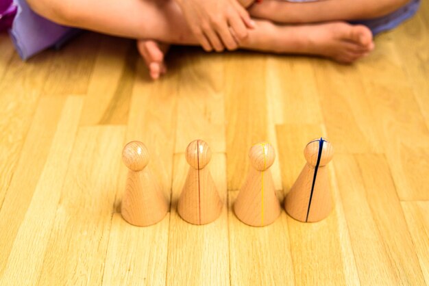 Low section of woman sitting by tokens on hardwood floor