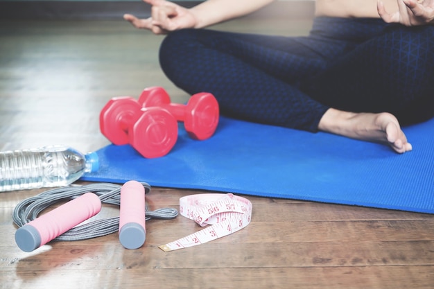 Low section of woman sitting on mat