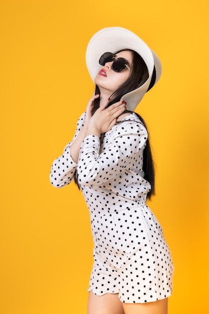 Low section of woman standing against yellow background