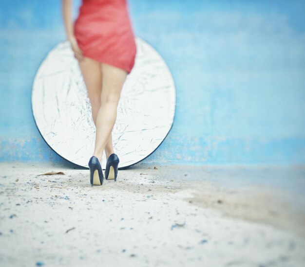 Low section of woman standing on beach