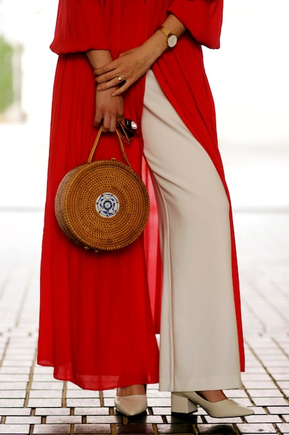 Low section of woman standing on footpath