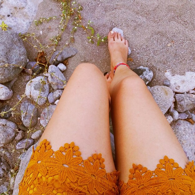 Low section of woman standing on ground