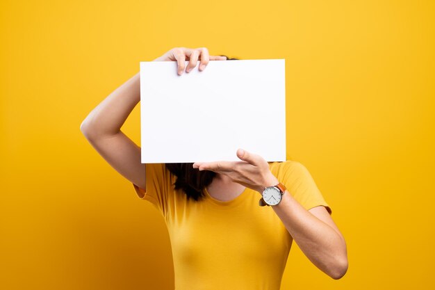 Low section of woman standing on paper