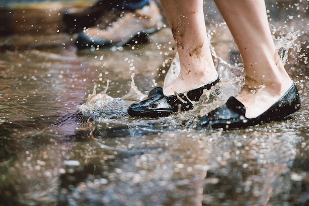 Photo low section of woman standing in puddle on road