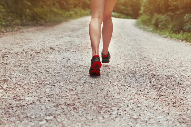 Low section of woman standing on road