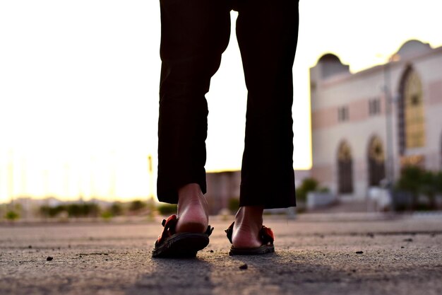 Low section of woman standing on street