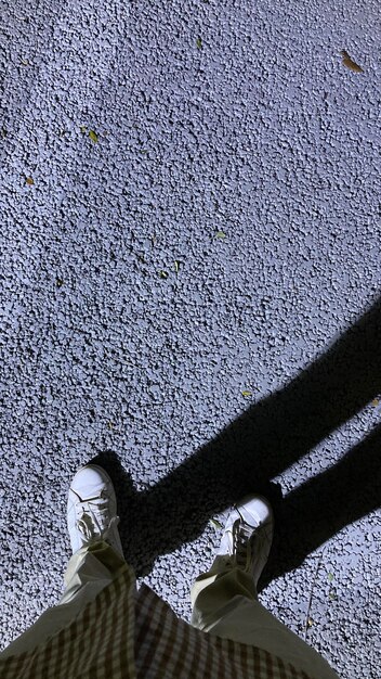 Low section of woman standing on tiled floor