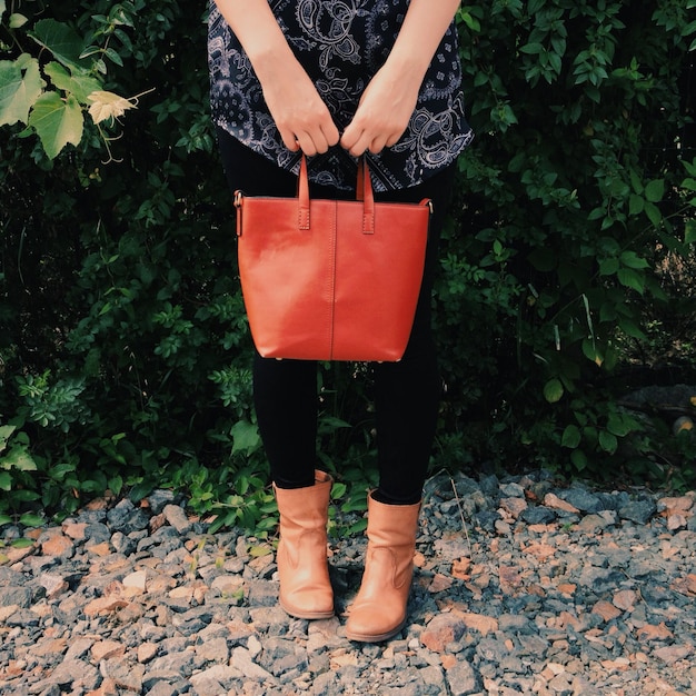 low section of woman wearing boot standing outdoors