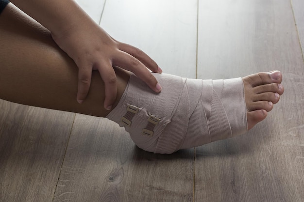 low section of woman with broken leg on hardwood floor