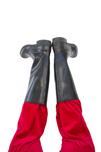 Lower half of santas legs with his black boots on white background