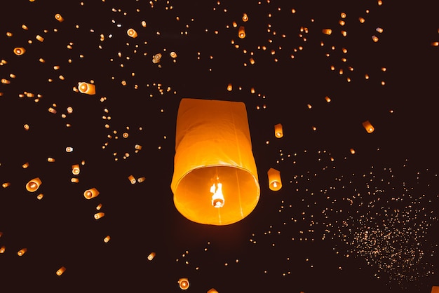 Loy krathong festival, thai new year party with floating lanterns release in the night sky