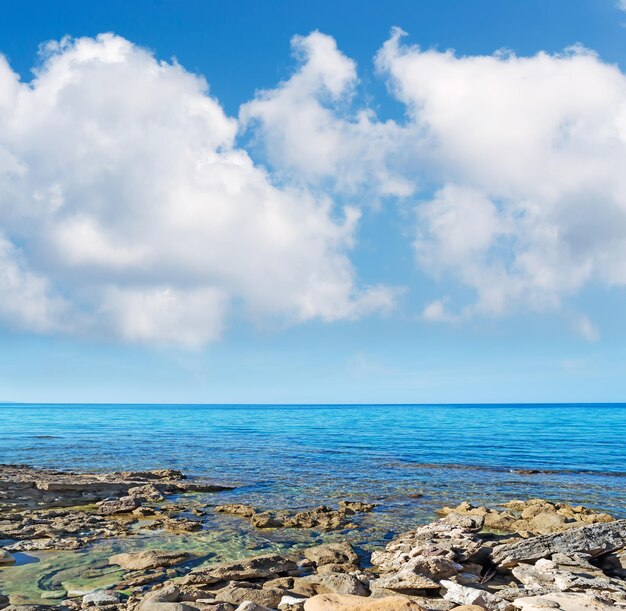 Lu bagnu rocky shore under a cloudy sky