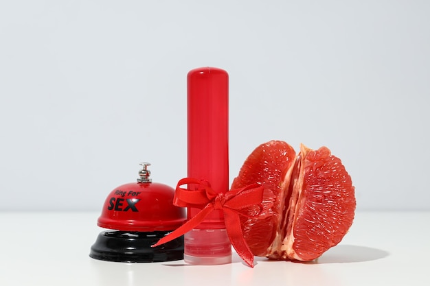 Lubricant with a bow next to a grapefruit and a twin for sex