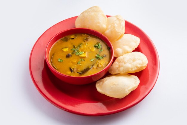 Luchi Cholar Dal or Fried bread made of flour served along with curried Chana or Bengal gram