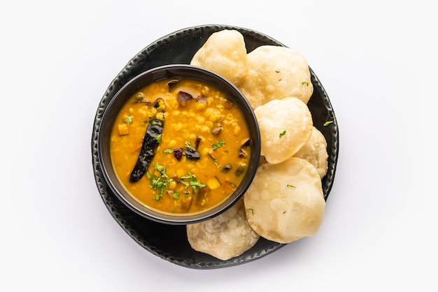 Luchi Cholar Dal or Fried bread made of flour served along with curried Chana or Bengal gram