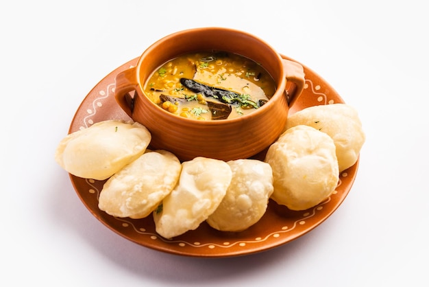 Luchi Cholar Dal or Fried bread made of flour served along with curried Chana or Bengal gram