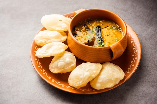 Luchi Cholar Dal or Fried bread made of flour served along with curried Chana or Bengal gram