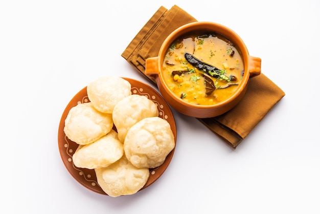 Luchi Cholar Dal or Fried bread made of flour served along with curried Chana or Bengal gram