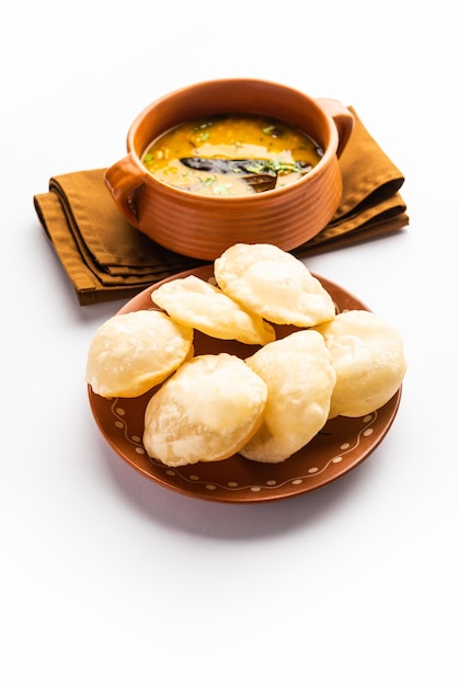 Luchi Cholar Dal or Fried bread made of flour served along with curried Chana or Bengal gram