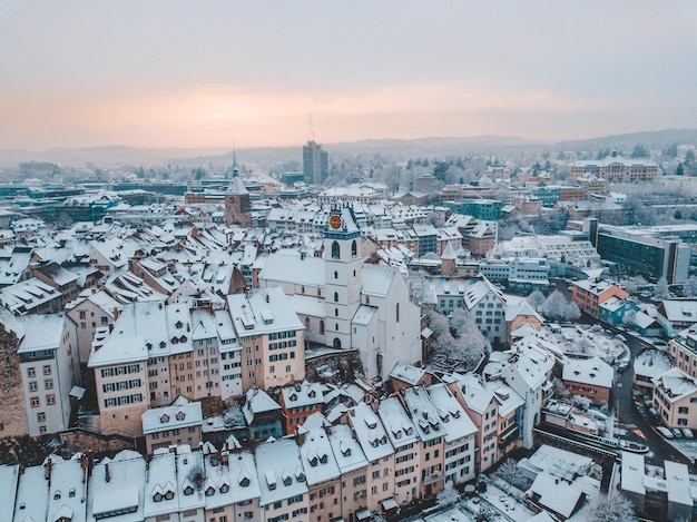 Luchtbeeld van een met sneeuw bedekt stadsbeeld tegen de hemel bij zonsondergang