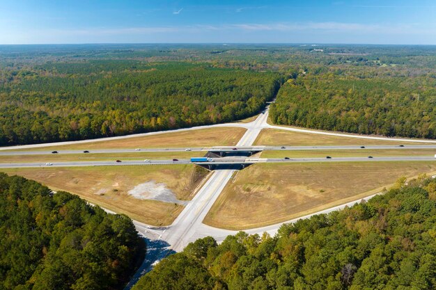 Foto luchtbeeld van een snelwegovergang met snel rijdende auto's en vrachtwagens in het amerikaanse platteland interstate transportinfrastructuur in de vs