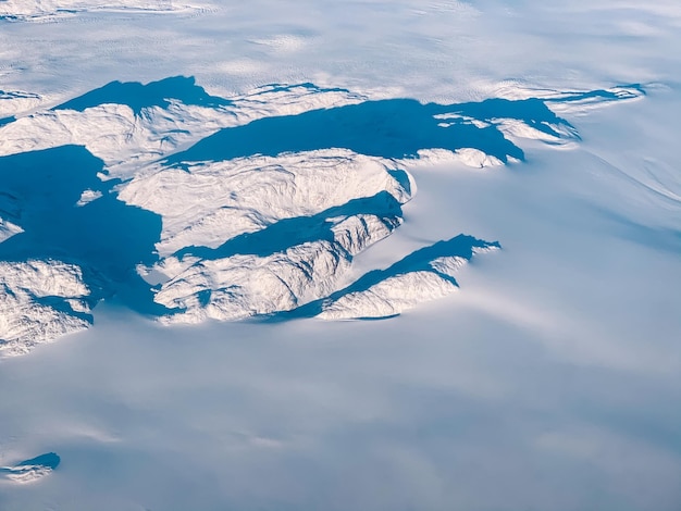 Foto luchtfoto van besneeuwde bergen tegen de hemel