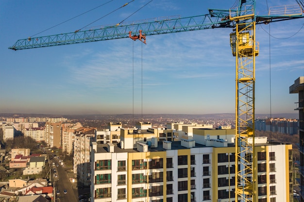 Luchtfoto van betonnen frame van hoog flatgebouw in aanbouw in een stad.