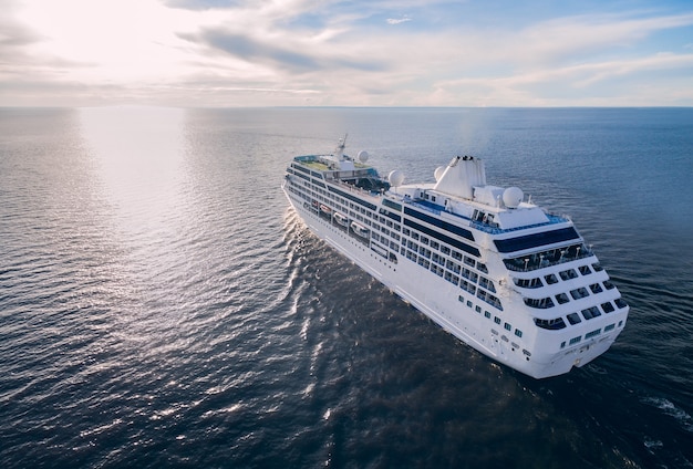 Luchtfoto van cruiseschip zeilen in de open zee bij zonsondergang