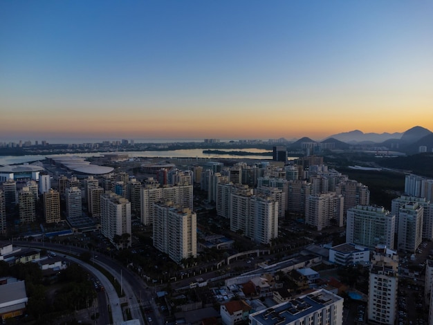 Luchtfoto van de lagune van Jacarepagua in Rio de Janeiro Brazilië Residentiële gebouwen en bergen rond het meer Barra da Tijuca strand op de achtergrond Zonnige dag zonsondergang Drone foto