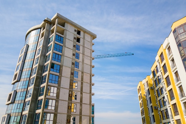 Luchtfoto van een hoog woonflatgebouw met verdiepingsnummers op de muur in aanbouw.