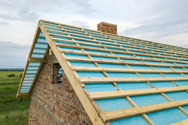 Foto luchtfoto van een houten dakframe van een bakstenen huis in aanbouw