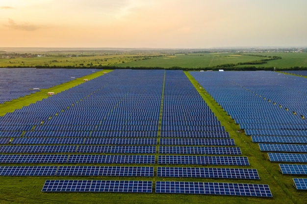 Luchtfoto van grote duurzame elektriciteitscentrale met vele rijen fotovoltaïsche zonnepanelen voor het produceren van schone elektrische energie in de avond Hernieuwbare elektriciteit zonder emissieconcept