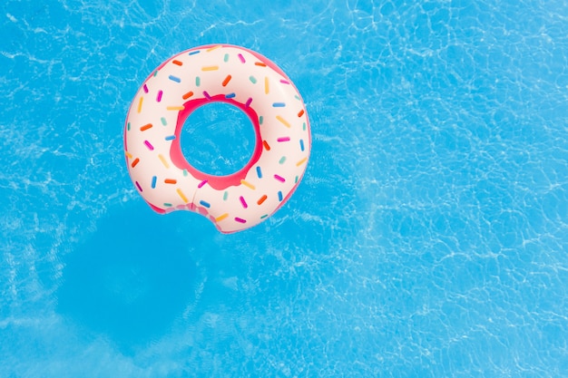 Luchtfoto van grote roze donut op de achtergrond van het zwembad