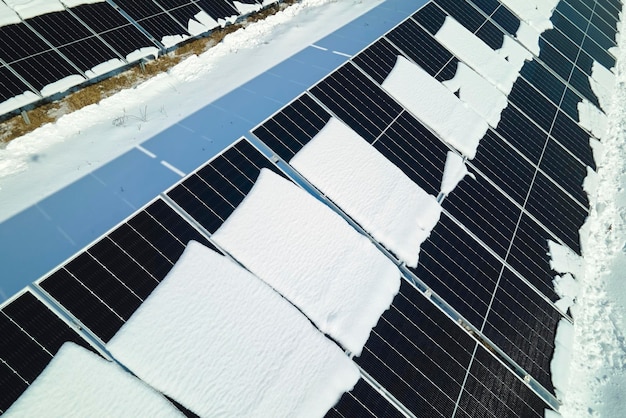 Luchtfoto van sneeuw die smelt van overdekte fotovoltaïsche zonnepanelen bij duurzame elektrische centrales voor het produceren van schone elektrische energie Lage effectiviteit van hernieuwbare elektriciteit in de winter