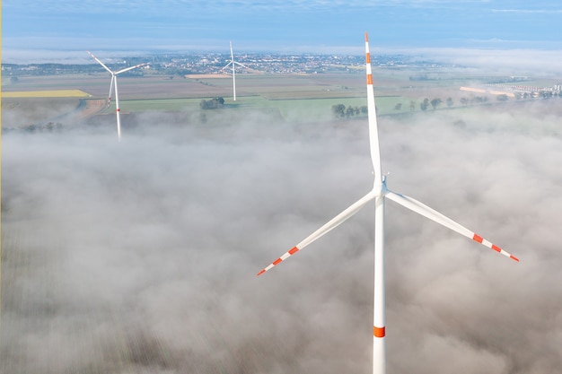 Luchtfoto van windturbine in mist, milieu, hernieuwbare energie, stroomopwekking, zomerlandschap, drone