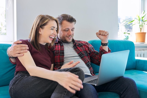 Luck happiness joy victory won happy emotional middle aged\
couple looking in laptop