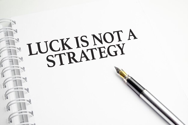 Luck is not A Strategy words with pen and paper