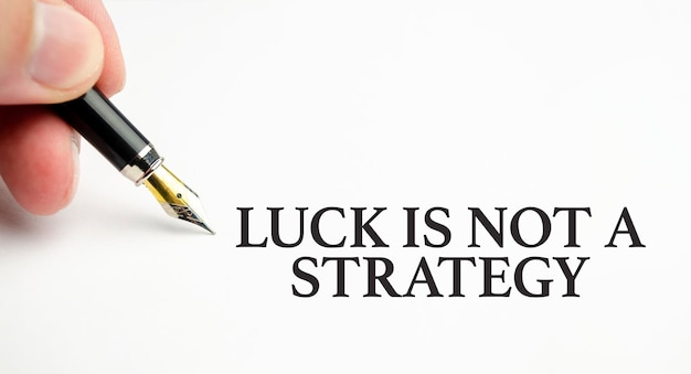 Luck is not A Strategy words with pen and paper