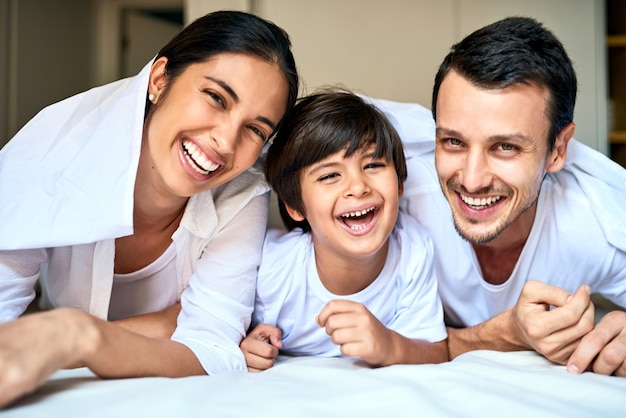 Lucky to be surrounded by Mom and Dads love Portrait of a happy family bonding together at home