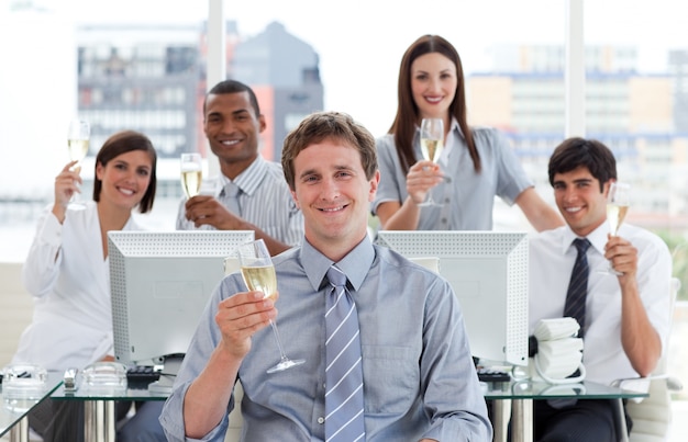 Lucky business team drinking champagne