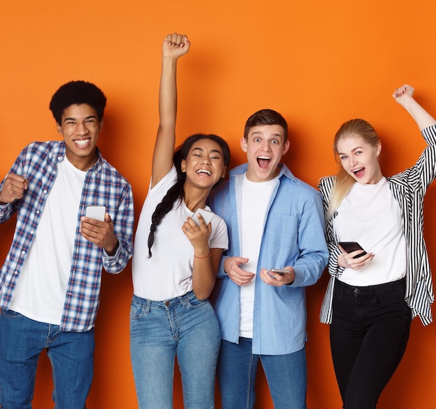 Lucky friends Students with phones screaming over background