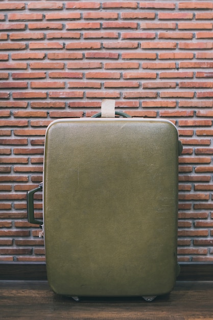 Luggage against brick wall