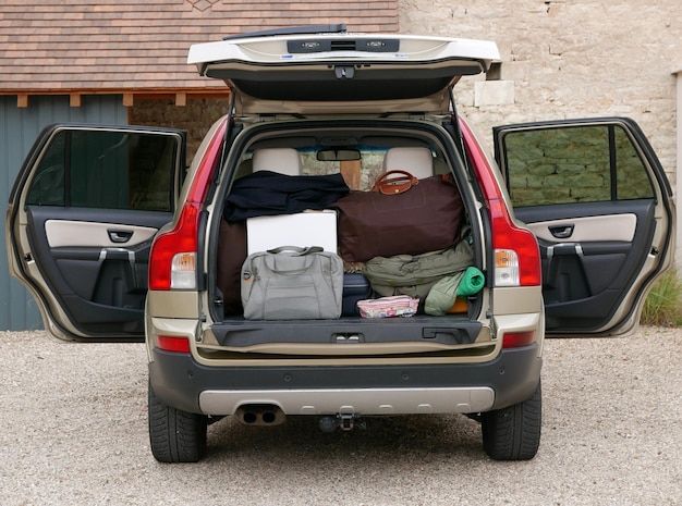 Luggage in car against building