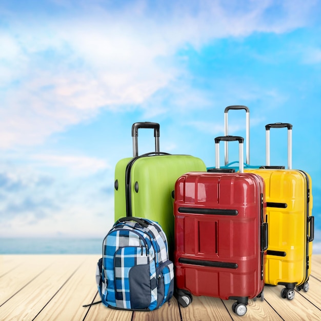 Багаж, состоящий из больших чемоданов, рюкзаков и дорожной сумки, изолированных на белом