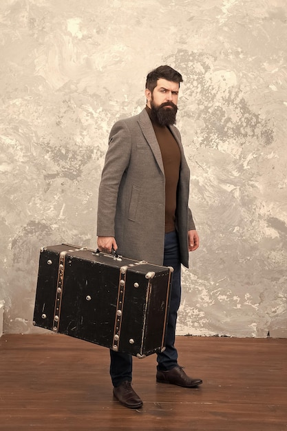 Luggage insurance Man well groomed bearded hipster with big suitcase Travel and baggage concept Hipster traveler with baggage Ready for relocation with baggage Start journey On way to new life