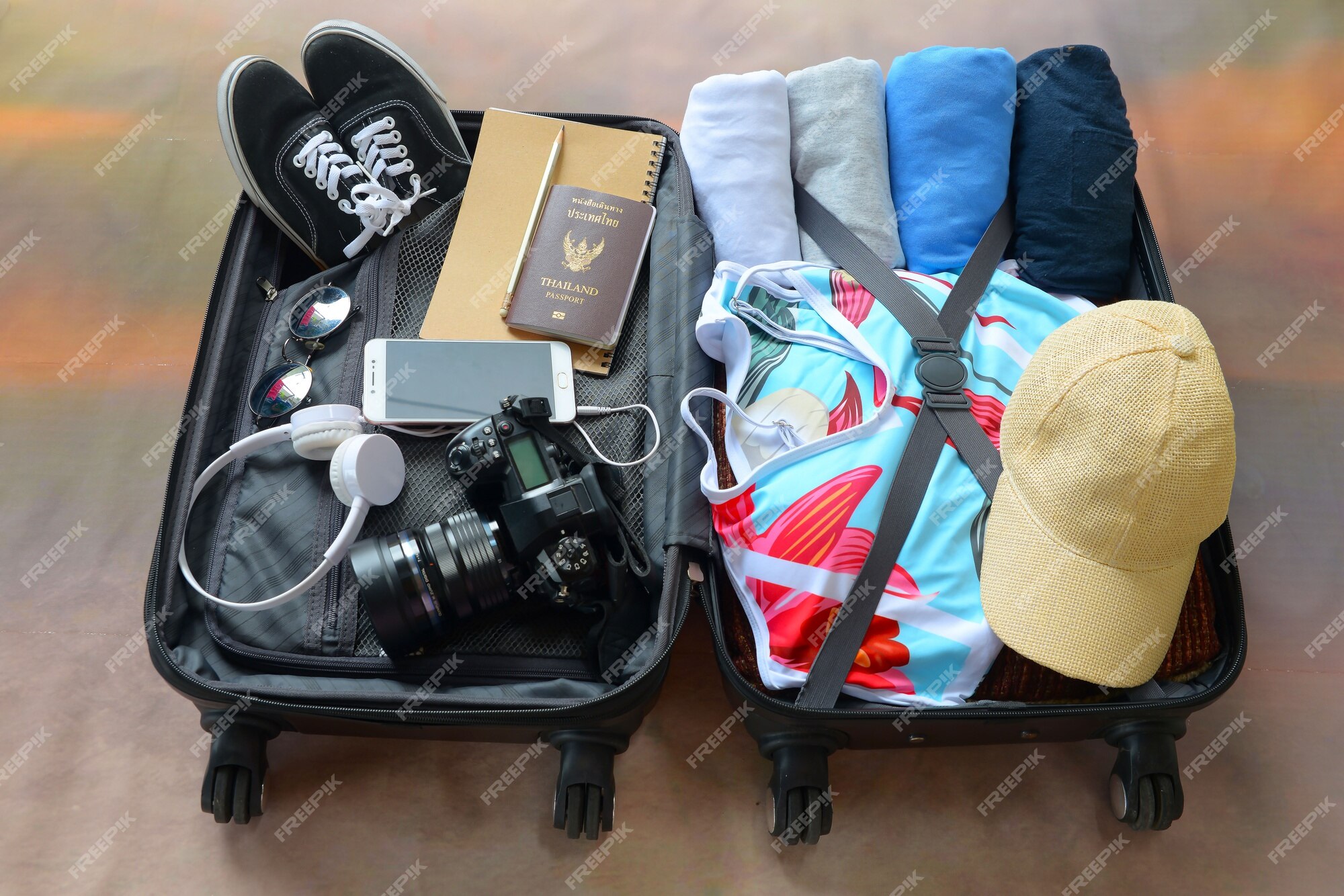 Crop woman packing suitcase on bed - a Royalty Free Stock Photo